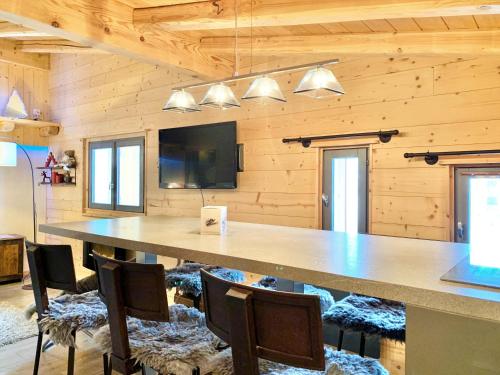 a large conference room with a large table and chairs at Homency - Résidence Ménandière E6 in L'Alpe-d'Huez