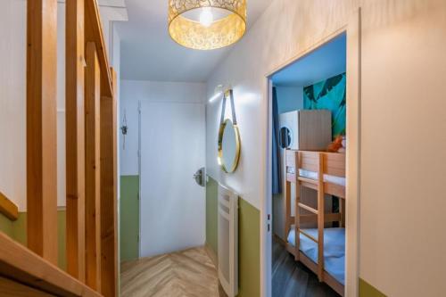 a hallway with a room with a bed and a mirror at Jungle Duplex with pool 5 min Disneyland in Serris