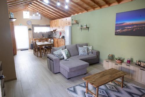 a living room with a couch and a table at Açores à Mesa House Casa do Terreiro in Terra Chã