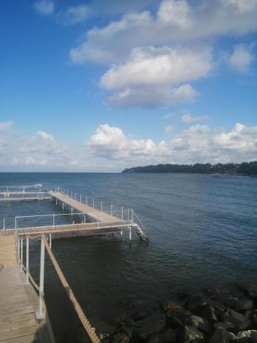 a dock on a body of water at Minihus til havn, strand, vand og by i Gilleleje in Gilleleje