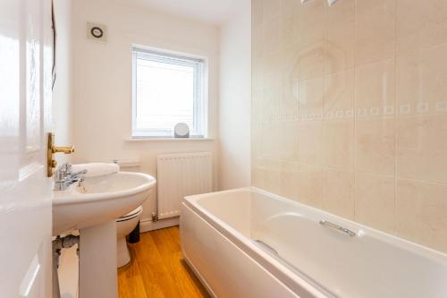 a bathroom with a tub and a sink and a bath tub at Brancepeth Place in Shildon