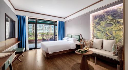a hotel room with a bed and a couch at Nostalgia S Hotel Kunming Old Street 时光漫步S酒店 昆明火车北站穿心鼓楼地铁站店 Free fresh ground coffee,Free laundry service in Kunming