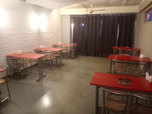 a row of tables and chairs in a room at Stays - Golf Course Road in Gurgaon