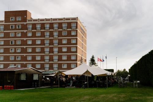 a group of tents in front of a building at ARVA Santiago León in León