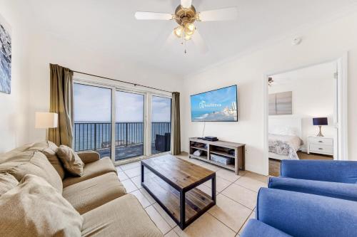 a living room with a couch and a table at Crystal Tower Condos in Gulf Shores