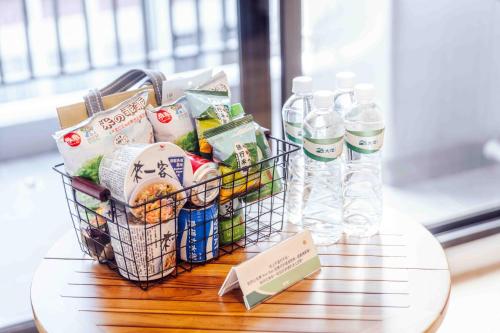 a basket of food and water bottles on a table at kaori B&B in Chishang