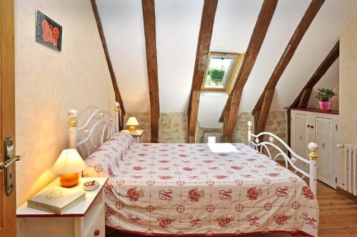 a bedroom with a bed and a table with a lamp at Gites de france 6 personnes au teil in Albaret-le-Comtal