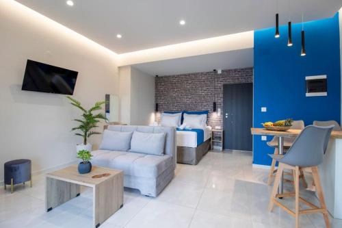 a living room with a couch and a bed at Blue Heaven Studio with Seaview in Limín Khersonísou