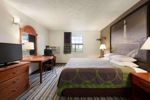 a hotel room with a bed and a desk at Super 8 by Wyndham Colorado Springs/Afa Area in Colorado Springs