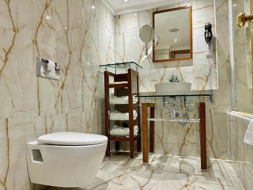 a bathroom with a toilet and a sink at Victoria Crown Plaza Hotel in Lagos