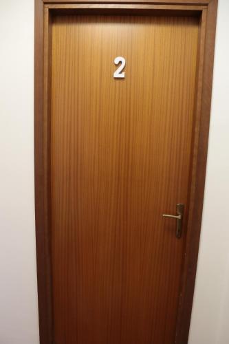a wooden door with the number two on it at Guest House Bagnolo in Bagnolo in Piano
