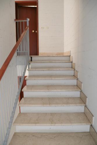 a set of stairs in a building with a door at Guest House Bagnolo in Bagnolo in Piano