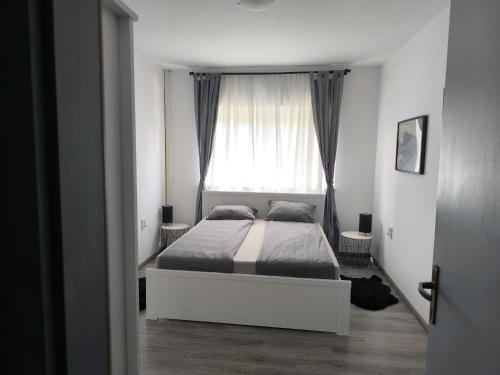 a bedroom with a bed in front of a window at Apartments Sabo in Kraljevica