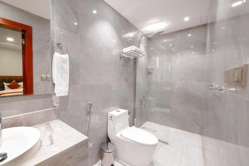 a bathroom with a toilet and a sink and a shower at Al Masem Serviced Apartments - Al Olaya - Exit 5 in Riyadh