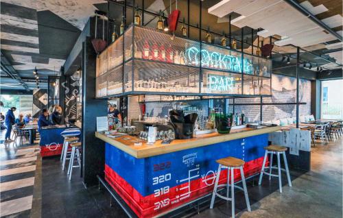 a bar in a restaurant with a counter and stools at Priwallpromenade 2, Whg 5 in Travemünde