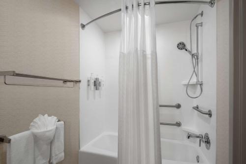 a bathroom with a shower with a white shower curtain at Hilton Garden Inn Rock Hill in Rock Hill