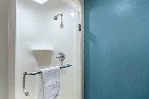 a bathroom with a blue door and a towel at Sleep Inn Clearwater-St Petersburg in Clearwater