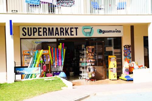 a store front of a super market with colorful items at Club Hotel Aguamarina in Arenal d'en Castell