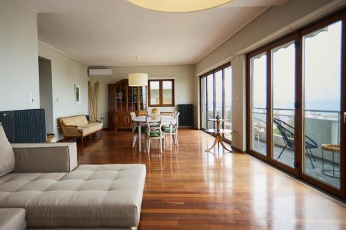 a living room with a couch and a table at Panoramic Loft in Chios