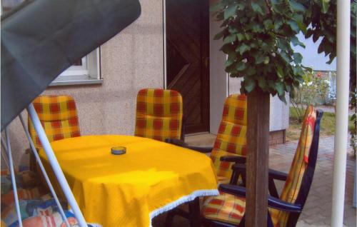 a yellow table and chairs with a yellow table cloth at Holiday Home Am Wiesengrund V in Löcknitz