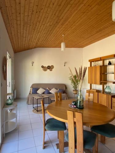 un salon avec une table et un lit dans l'établissement Gîtes Côte de Jade, proche plage et commerces, de 2 à 6 personnes, à La Bernerie-en-Retz