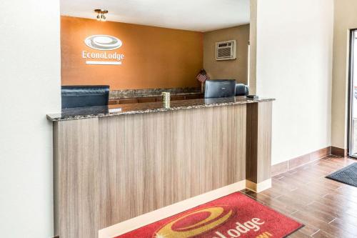 a hotel lobby with a bar with a restaurant sign at Econo Lodge La Crosse North in La Crosse