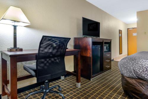 a hotel room with a desk and a bed at Econo Lodge La Crosse North in La Crosse