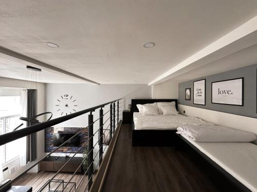 a bedroom with a bed and a balcony at Grand Viceroy Apartments - Gothic Tower View in Prague
