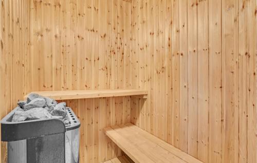 a sauna with a trash can and a wooden wall at Four-Bedroom Holiday Home In Aabenraa in Aabenraa