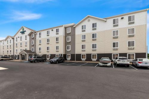 a large building with cars parked in a parking lot at WoodSpring Suites Tulsa in Tulsa