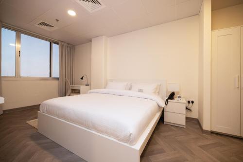 Postel nebo postele na pokoji v ubytování Riggae Tower Hotel