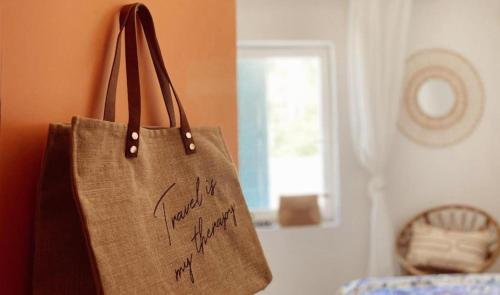 a bag with writing on it is hanging on a wall at Casa di Campara in Neum