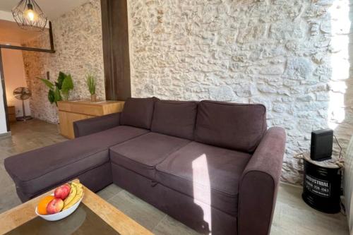 un salon avec un canapé marron et un bol de fruits dans l'établissement Atelier des rêvesVieuxPortProche PlagesLaCiotat, à La Ciotat