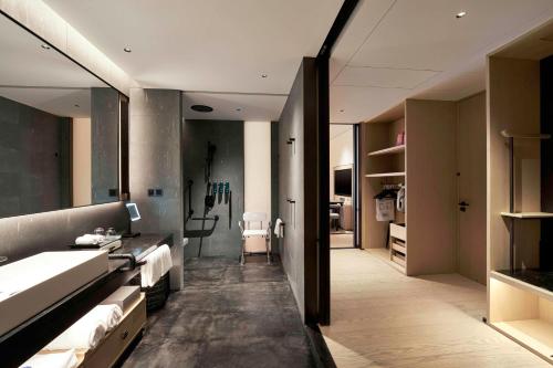 a bathroom with two sinks and a shower at Hilton Nanjing Niushoushan in Nanjing