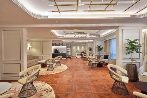 a salon with chairs and tables and a waiting room at Doubletree By Hilton Bengaluru Whitefield in Bengaluru
