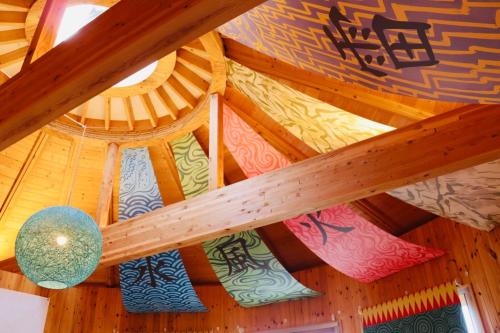 a wooden ceiling with many different types of art on it at GRAND CHARIOT Hokutoshichisei 135° in Awaji