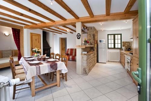 a kitchen and dining room with a table and chairs at Gite le mas 6 personnes in Allenc