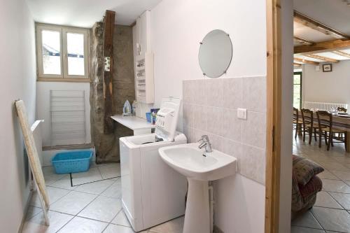 a white bathroom with a sink and a mirror at Gite le mas 6 personnes in Allenc