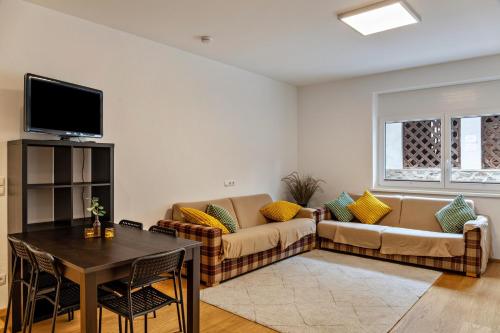 a living room with a couch and a table at Ferienwohnung Brandbergblick in Mayrhofen