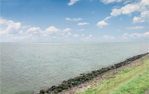 a large body of water with a line of rocks at De Koestal in Wijdenes