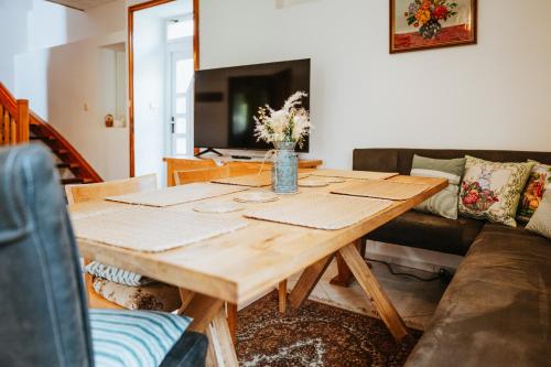 a living room with a wooden table and a couch at Lichkovská chalupa in Lichkov
