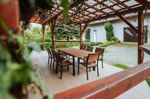 a wooden table and chairs on a patio at Lichkovská chalupa in Lichkov