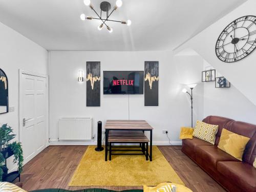 a living room with a table and a couch at Stylish House Near Hospital with Free Parking in Stoke on Trent