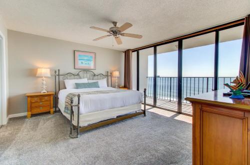 a bedroom with a bed and a balcony at 1114 Boundless Awe by Atlantic Towers in Carolina Beach
