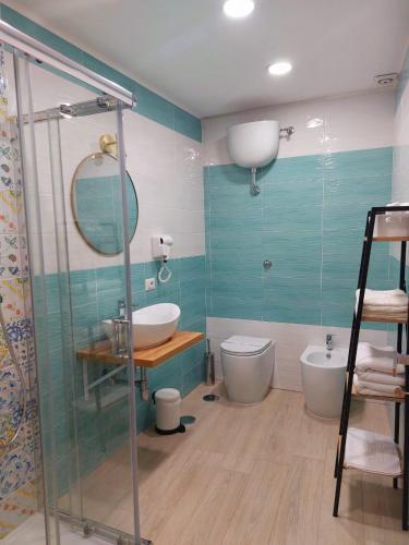 a bathroom with a shower and a sink and a toilet at AL centro in Frattamaggiore