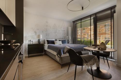 Ένα ή περισσότερα κρεβάτια σε δωμάτιο στο Scala Apartamenty by Moderna Profit- Łąkowa 60E z parkingiem