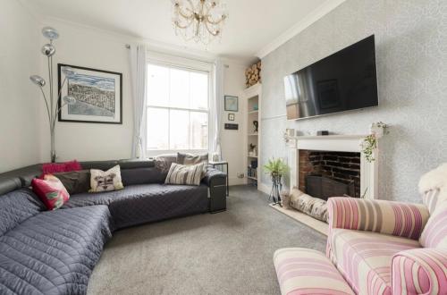 a living room with a couch and a fireplace at Ramsgate Retreat in Kent