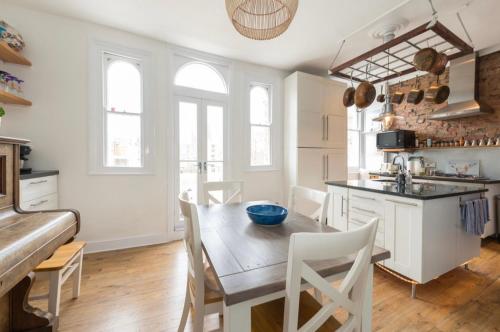 a kitchen and dining room with a table and chairs at Ramsgate Retreat in Kent