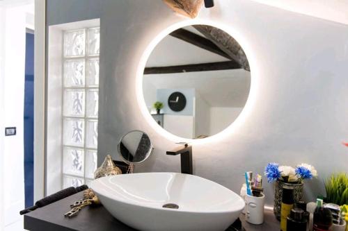 a bathroom with a white sink and a mirror at attico spettacolare vista mare in Camogli