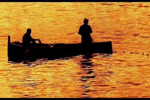 two people sitting on a boat in the water at attico spettacolare vista mare in Camogli